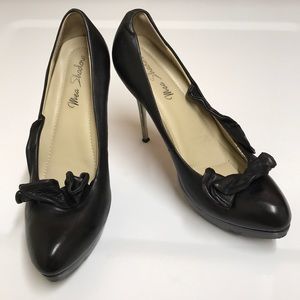 Mea Shadow black leather platform heels with ruffles